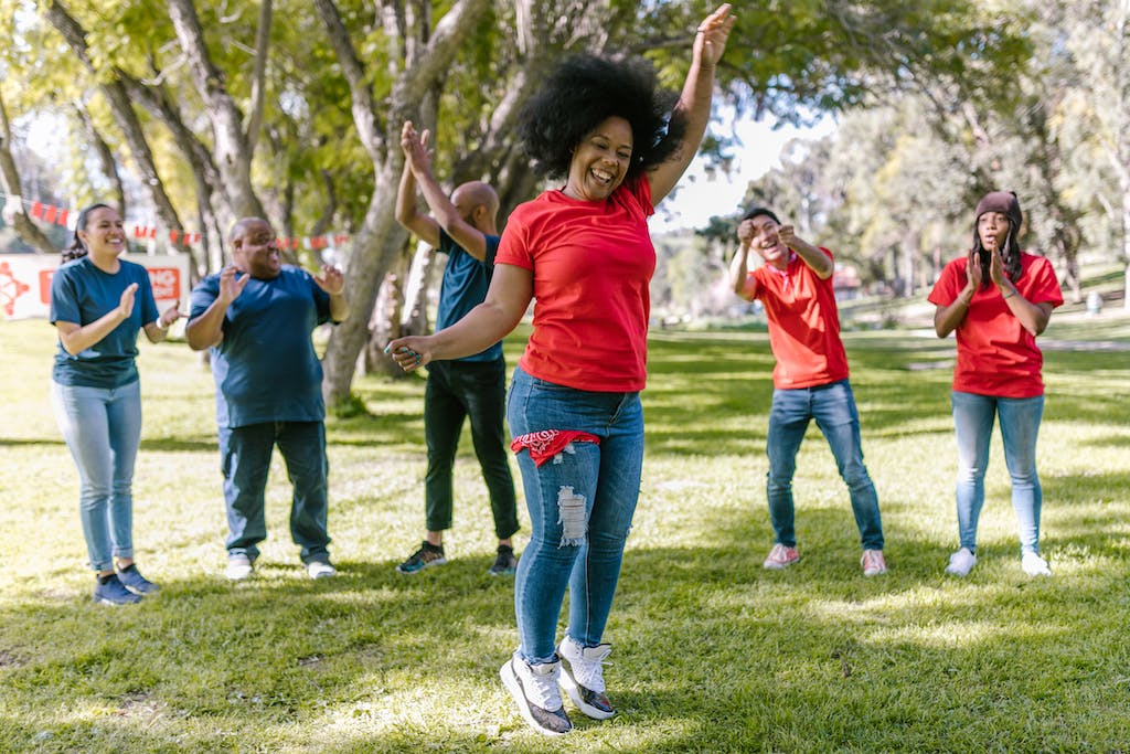 Woman in Red T-shirt Dancing With People Cheering